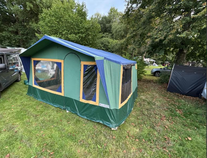 Tent wagon set up on a grassy pitch