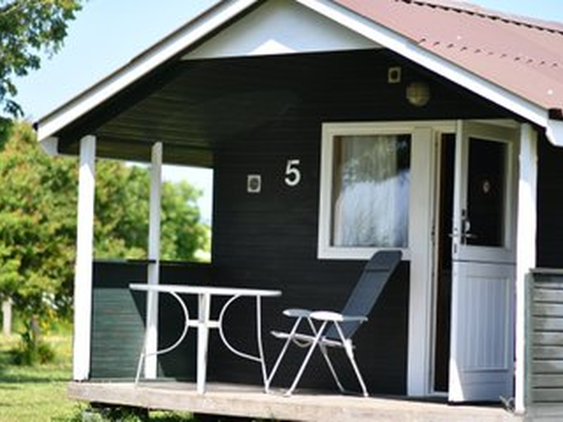 Wooden camping cabin among dune grass